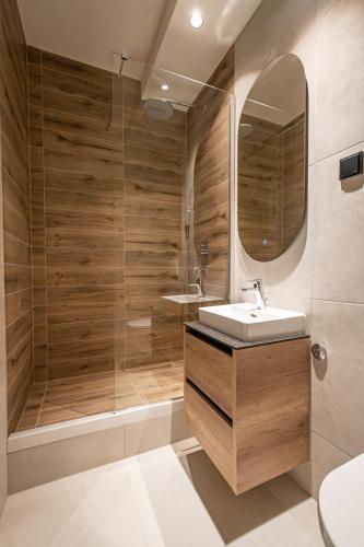 a bathroom with a sink and a shower at Sinfonia Lux 1205 in Sajmište