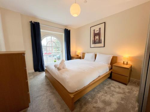 a bedroom with a large bed and a window at Duplex Apartment in Glasgow in Glasgow