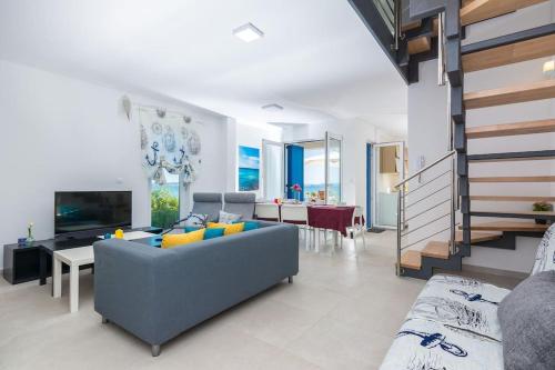 a living room with a blue couch and a table at Villa Miri Lavender in Privlaka