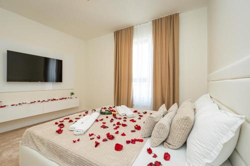 a bedroom with red roses on a bed at Sinfonia Lux 1205 in Sajmište