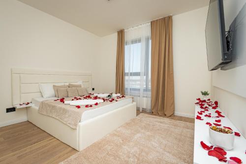 a bedroom with a bed with red petals on it at Sinfonia Lux 1205 in Sajmište