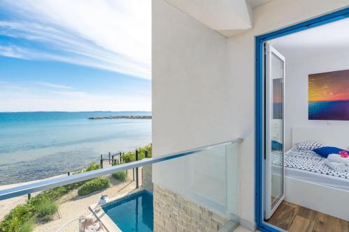 a balcony with a view of the ocean at Villa Miri Lavender in Privlaka