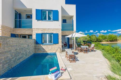 a villa with a swimming pool and a house at Villa Miri Lavender in Privlaka
