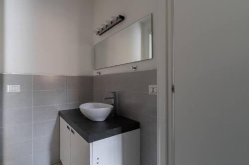 a bathroom with a sink and a mirror at Spazioso Loft: Coldilana14 in Milan
