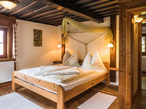 a bedroom with a wooden bed with a canopy at Streuobsthof Weissenbacher in Kindberg