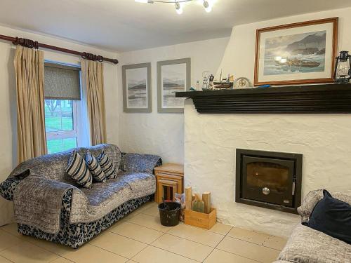 a living room with a couch and a fireplace at Bayview Holiday Home No 39 by Trident Holiday Homes in Dunmore East