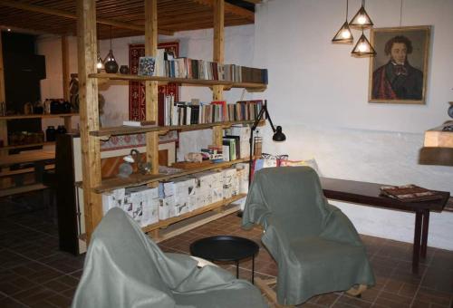 a room with two chairs and a table and books at Villa Mimi in Bazmakhpyur