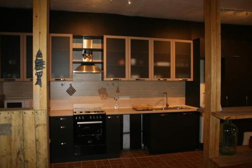 a kitchen with a sink and a stove top oven at Villa Mimi in Bazmakhpyur