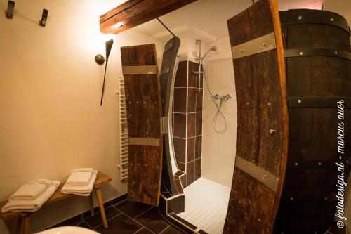 a bathroom with a shower with a large wooden structure at Streuobsthof Weissenbacher in Kindberg