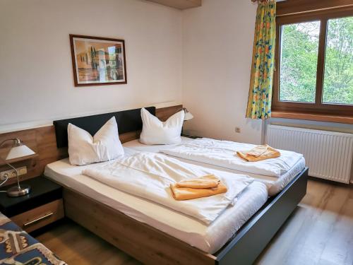a bedroom with two beds with towels on them at Gasthof Blankenberg 
