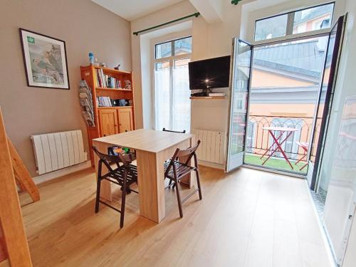 Un comedor con una mesa y dos sillas. en Le Gypaète, t1 bis, vue montagne, wifi, ascenseur, balcon, 6 personnes, en Cauterets