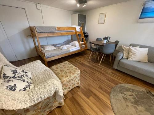 a living room with a bunk bed and a couch at Vid Gekås Ullared Boende B&B in Ullared