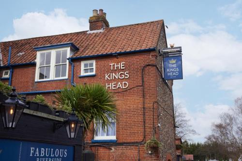 a brick building with the kings head sign on it at The Kings Head Wroxham by Greene King Inns in Wroxham