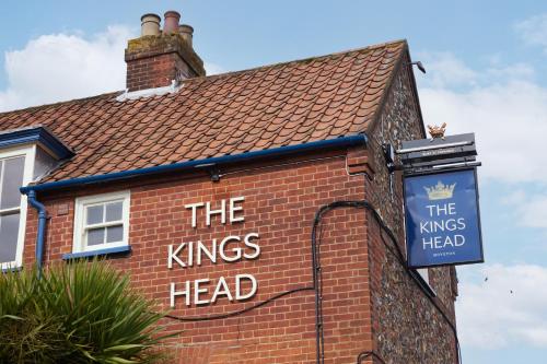 a sign on the side of a brick building at The Kings Head Wroxham by Greene King Inns in Wroxham