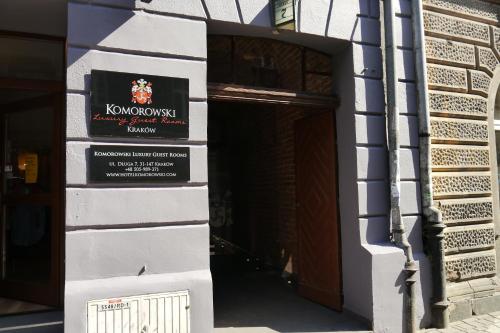 a door to a building with a sign on it at Komorowski Luxury Guest Rooms in Kraków