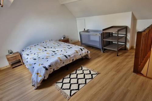 een slaapkamer met een bed en een bureau erin bij Petite maison de La Hague in Beaumont-Hague