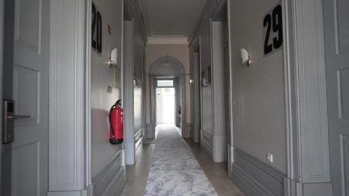 a hallway with a fire hydrant in the middle of a building at Hotel Senhor de Matosinhos in Matosinhos