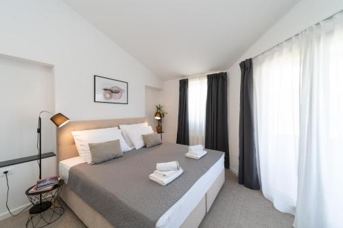 a bedroom with a bed with two towels on it at Holiday Home Kiara in Brtonigla