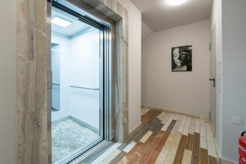 a glass door in a hallway with a tile floor at WOW studios for rent - bul Montevideo 25A - B in Sofia