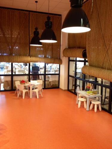 a room with tables and chairs and windows at Hotel Boutique Balandret in Valencia
