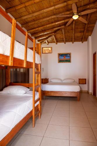 two bunk beds in a room with a ceiling at El Mirador de Vichayito in Vichayito