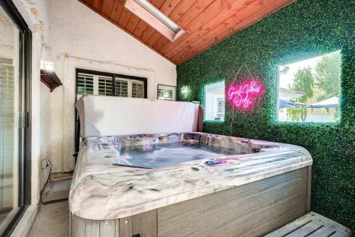 a bed in a room with a green wall at Luxury Vegas Home with 5BR, Casita, Hot Tub, and Pool in Las Vegas
