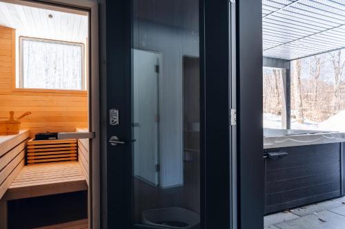 baño con aseo y puerta de cristal en Le coup de coeur du Lac Supérieur - 3 minutes from Tremblant! en Lac-Superieur