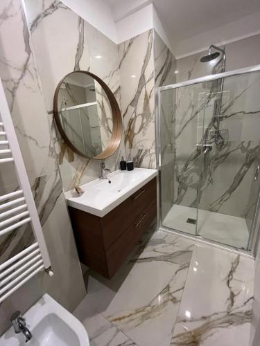 a bathroom with a sink and a mirror and a shower at Residenza Marcelli in Isernia