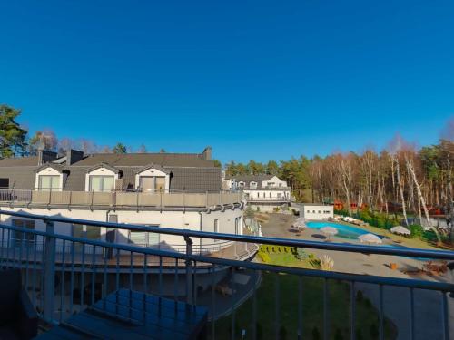 a view from the balcony of a house with a pool at VacationClub - Leśna 12A Apartament 24 in Pobierowo