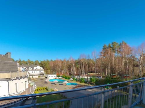 a balcony with a view of a yard at VacationClub - Leśna 12A Apartament 24 in Pobierowo