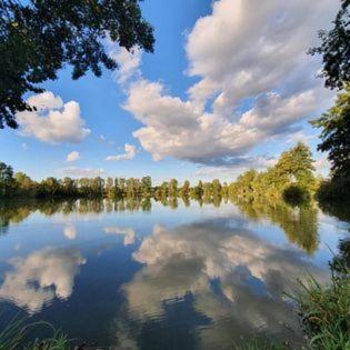 a reflection of clouds in a large lake at Przystanek w kolorach świata in Jelenia Góra