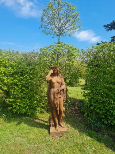 a statue of a woman standing in the grass at Château de Jallanges & Spa à Vouvray - 1h de spa incluse par jour in Vouvray