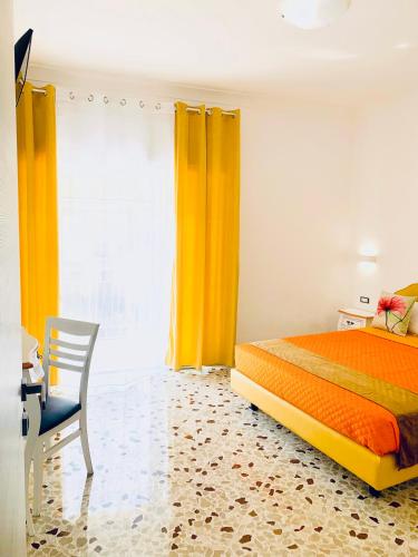 a bedroom with an orange bed and a chair at Floral Holiday in Minori