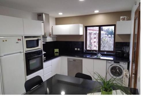 uma cozinha com armários brancos e uma máquina de lavar louça em Maison d'une chambre avec wifi a Vigneux sur Seine em Vigneux-sur-Seine