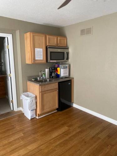 a kitchen with a counter and a microwave at Studio C Sleep 6- Bachelor/Bachelorette Parties! in Lake Ozark