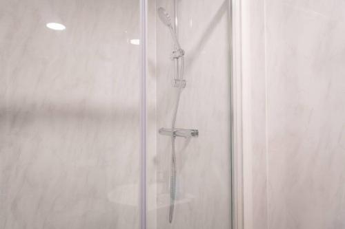 a shower with a glass door with a shower at Old Trafford : Stunning Studio in Manchester