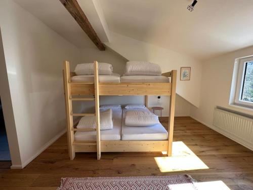 a bunk bed in a room with white pillows at Schöne FeWo im Allgäu für bis zu 10 Pers. in Bad Hindelang