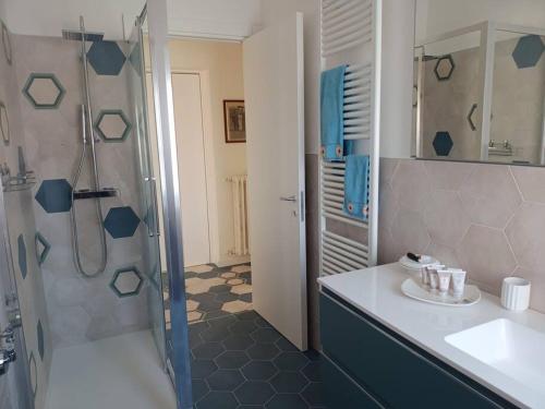 a bathroom with a shower and a sink and a toilet at Casa Tina in Verbania