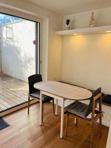 a dining room with a table and two chairs at Opal'House Face aux Remparts in Boulogne-sur-Mer