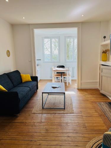 a living room with a couch and a table at Opal'House Face aux Remparts in Boulogne-sur-Mer