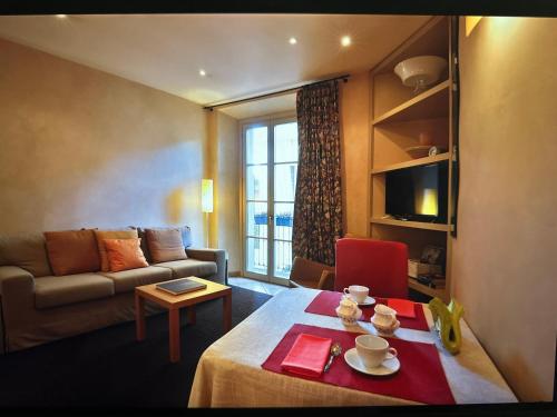 a living room with a couch and a table at Cernobbio lake suites in Cernobbio