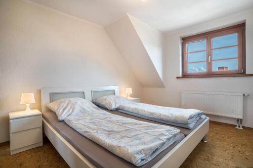 a bedroom with two beds and a window at Haus48 in Neuried