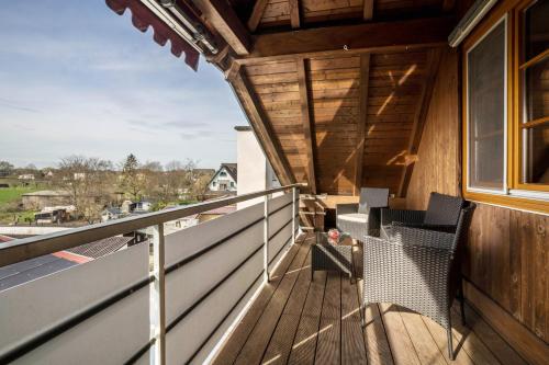 an outdoor deck with chairs and a window at Haus48 in Neuried