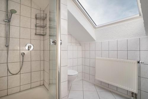 a bathroom with a shower and a toilet at Haus48 in Neuried