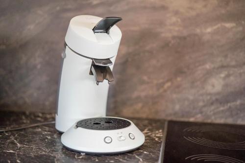 a white mixer sitting on a table with a remote control at Haus48 in Neuried