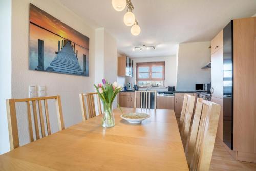 a kitchen and dining room with a table and chairs at Haus48 in Neuried