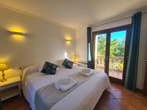 a bedroom with two beds and a large window at VILLA JACELIA in Sa Pobla