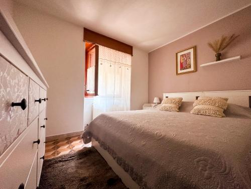 a bedroom with a large bed and a window at La Casetta di Giorgia in Fenis