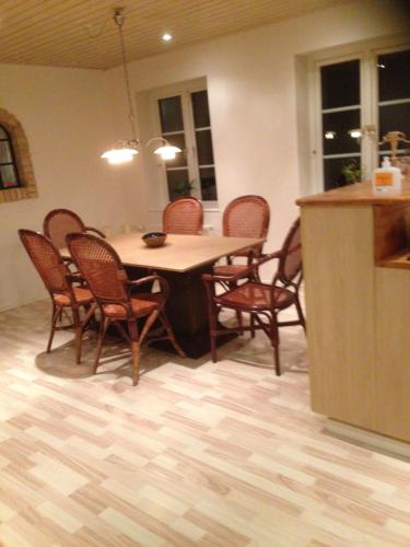 a dining room with a table and chairs at nedlagt gård i naturen med ro og fred og samtidig tæt på strand og fiskeri og indkøbsmuligheder in Nordborg