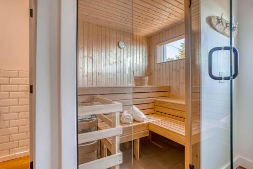 a sauna with wooden walls and a glass door at Walters Waldport in Waldport